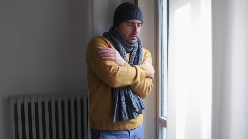 Video about one man feeling cold at home after home heating trouble.The shot gets slowly closer to the subject. Royalty-Free Stock Footage #1081096100