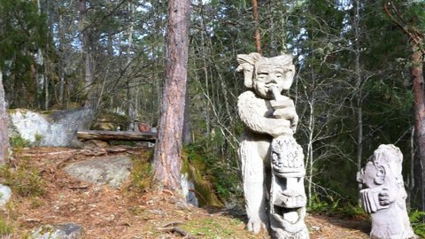 Gamleby, Sweden - April 02 2021: Forest Troll Statue Playing Instrument