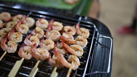 Panning of Grilled butter shrimps skewer in stick on stove