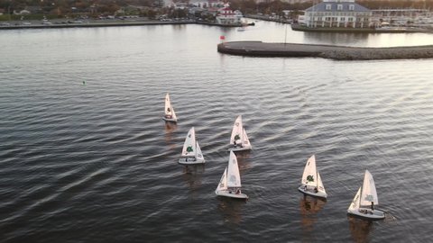 Dinghy Boats Sailing At Lake Pontchartrain During Sundown In New Orleans, USA. aerial, orbit