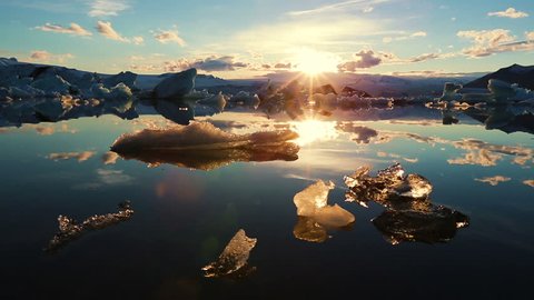 Icebergs Lighting up like Crystals During Sunrise in Glacier Lagoon. Aerial Shot. Iceland.