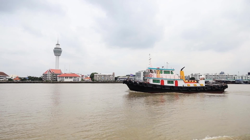 The ship is sailing in the middle of the river.