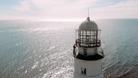 Amazing aerial panoramic view of the lighthouse. Old lighthouse on the seaside. Navigation equipment on the sea.