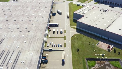 Aerial view of warehouse storages or industrial factory or logistics center from above. Aerial view of industrial buildings and equipment
