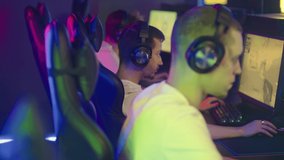 Professional team of gamers is participating in a video game tournament. Professional team of gamers is playing the shooter game. Professional team of gamers are trying to kill their opponents.