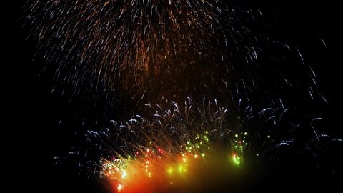 4K. 2022. loop seamless of real fireworks background. abstract blur of real golden shining fireworks with bokeh lights in the night sky. glowing fireworks show. New year's eve fireworks celebration. 
