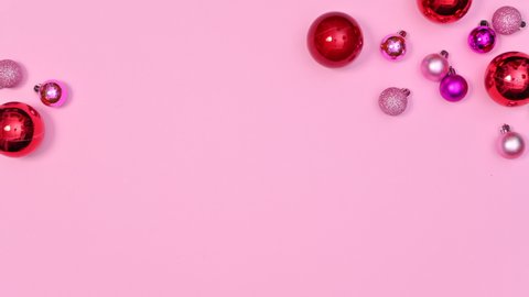 6k Minimal Christmas arrangement of red and pink Christmas balls appear on pastel pink theme. Stop motion