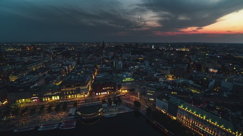 Hamburg, Germany - circa 2021: Establishing Aerial View Shot of Hamburg De, Mecklenburg-Western Pomerania, Germany, late sunset, waterfront, old town, Biennenalster