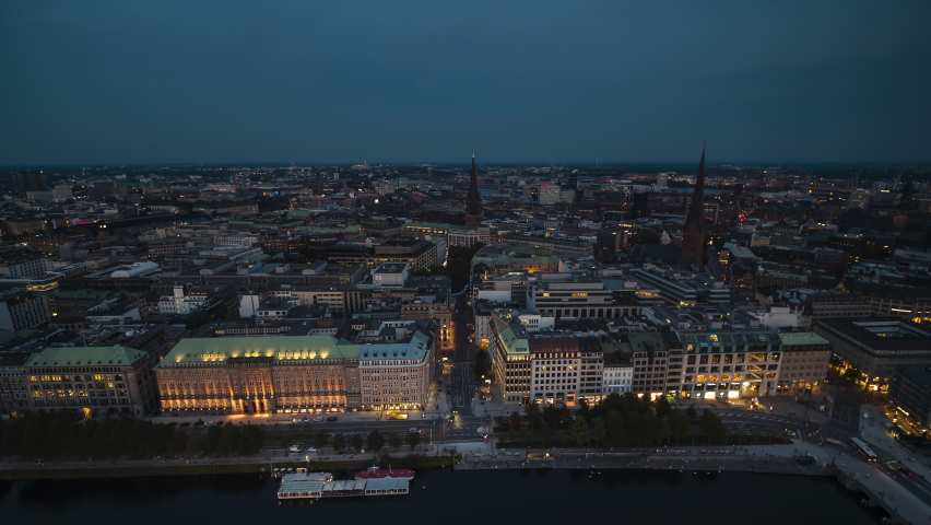 Establishing Aerial View Shot of Hamburg De, Mecklenburg-Western Pomerania, Germany, at night evening, city watrfront of Biennenalster