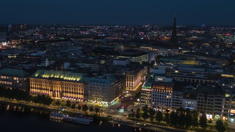 Hamburg, Germany - circa 2021: Establishing Aerial View Shot of Hamburg De, Mecklenburg-Western Pomerania, Germany, at night evening, busy evening