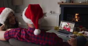 Caucasian couple on video call with santa claus at christmas time. christmas, festivity and communication technology.