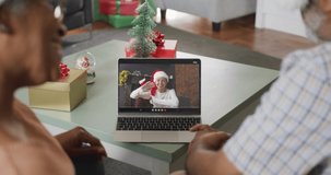 Happy senior african american couple on video call on laptop with female friend at christmas time. christmas, festivity and communication technology.