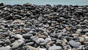 Seaside with gray stones over the beach