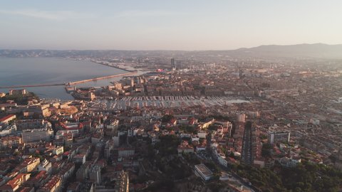 Establishing Aerial View Shot of Marseille Fr, Bouches-du-Rhone, Provence-Alpes-Cote d'Azur, France, hazy morning, push into the port of Marseille