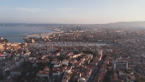 Establishing Aerial View Shot of Marseille Fr, Bouches-du-Rhone, Provence-Alpes-Cote d'Azur, France, hazy morning, slow track left, port of Marseille