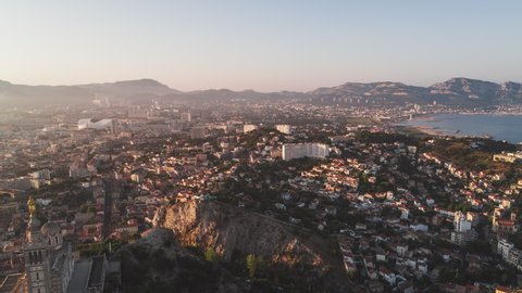 Establishing Aerial View Shot of Marseille Fr, Bouches-du-Rhone, Provence-Alpes-Cote d'Azur, France, golden hour, push in on super wide