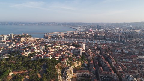 Establishing Aerial View Shot of Marseille Fr, Bouches-du-Rhone, Provence-Alpes-Cote d'Azur, France, super wide, push into port