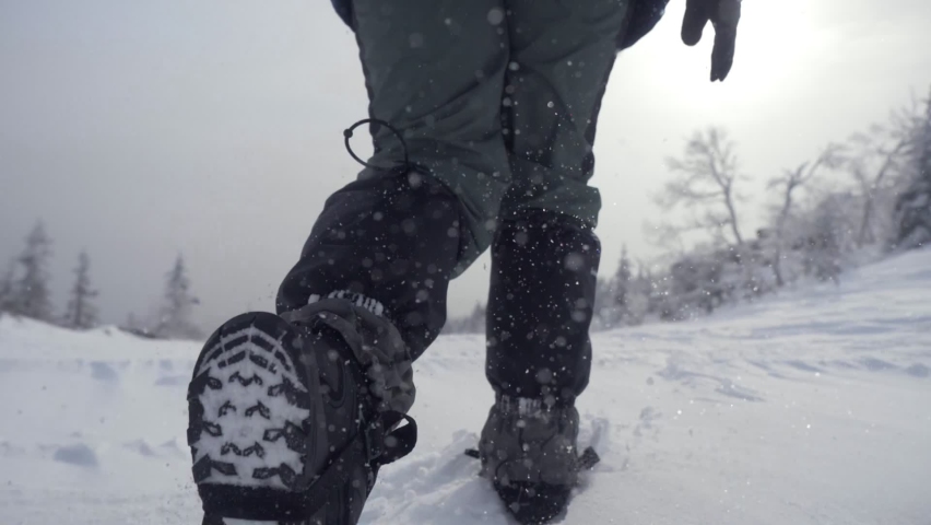 Hiker walking up climbing snow mountains. Snow walking hiker hiking in winter. Active lifestyle mountain climbing winter. travel in winter concept Royalty-Free Stock Footage #1081171793