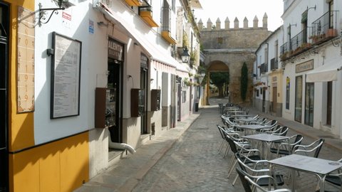 August 13, 2021, Cordoba, Spain. Empty outdoor restaurant in an ancient narrow alley in Cordoba, with chairs and tables. 