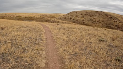 First person POV from riding a mountain bike on a single track trail on Colorado prairie, late October scenery in Soapstone Prairie Natural Area