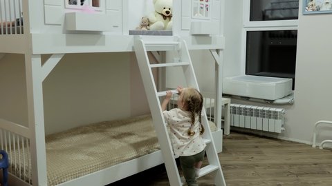 Mom and baby play on a bunk bed