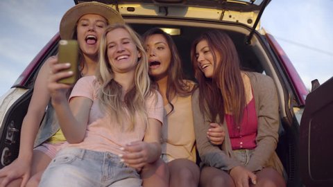 Group Of Wild And Fun Teens Hang Out In Back Of SUV, Girl Grabs Friend's Phone To Take Selfies (4K)