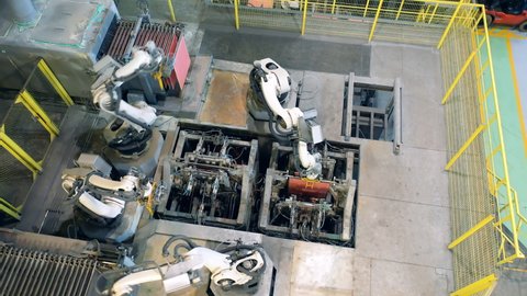Top view of modern robotic machines working with copper plates
