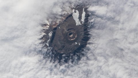 Mountain peak from clouds view from sky, aerial satellite scenic landscape of Kilimanjaro mount in Tanzania, Africa. Animation based on Nasa images