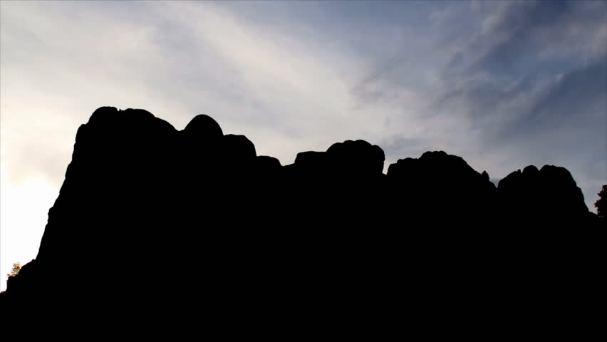Zoom in of Mount Rushmore (National Memorial) at sunset - silhouette in Keystone, South Dakota 3. A sculpture carved into the granite face of Mount Rushmore.