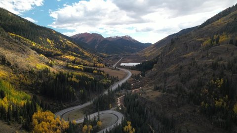 Curving mountain highway through alpine valley. Aerial 4K drone video of Million Dollar Highway in southwest Colorado.