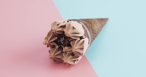 Time-lapse Ice-Cream Cone Chocolate Melting isolated on the floor blue and pink background.