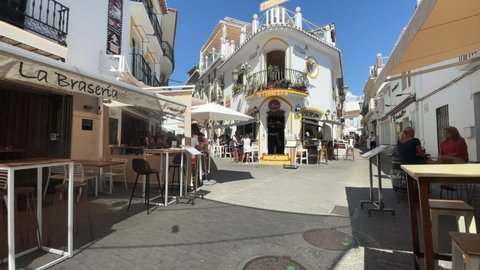 Nerja, Spain, Sept. 17, 2021.
Walkng the pedestrian area in downtown city Nerja at the Costa del Sol, Andaluisia, Spain. Several people are walking in the street
