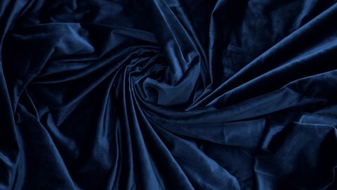 Elegant soft shiny dark blue, Oxford blue velvet fabric textile. Abstract fashion, interior fabric background. Zooming in.