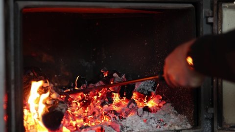 Cooking baked potatoes in foil and charcoal. Burning coals in fireplace. High quality 4k footage