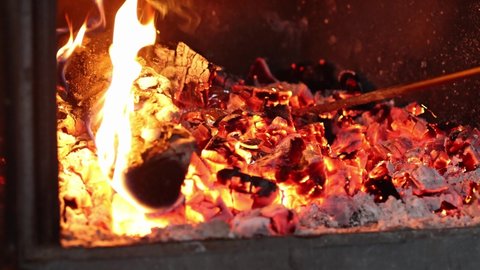 Cooking baked potatoes in foil and charcoal. Burning coals in fireplace. High quality 4k footage