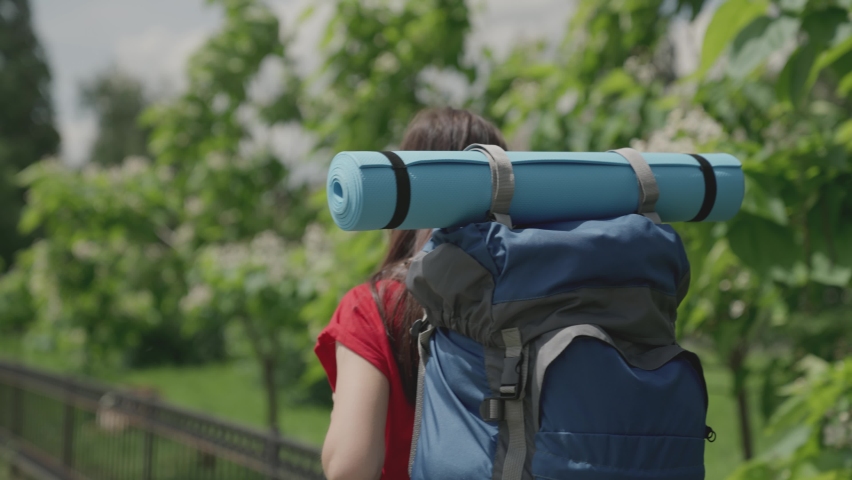 Girl traveler millennial with blue backpack and yoga mat travels, explore local attractions, active woman in search of adventure, happy life, hiking vacation, enjoy nature outdoors, slow motion | Shutterstock HD Video #1081232990