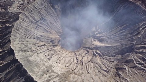 Aerial view of Mount Bromo Crater, active volcano with smoke in East Jawa, Indonesia. Volcano crater Mount Gunung Bromo, active volcano, Tengger Semeru National Park. 4K video. Wonderful Indonesia.