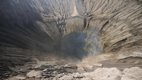 Mount Bromo Crater, active volcano with smoke in East Jawa, Indonesia. Aerial view of volcano crater Mount Gunung Bromo, active volcano, Tengger Semeru National Park. 4K video. Wonderful Indonesia.