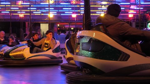Netherlands - 23 october 2021, Hilversum: People driving bumper car at amusement park
