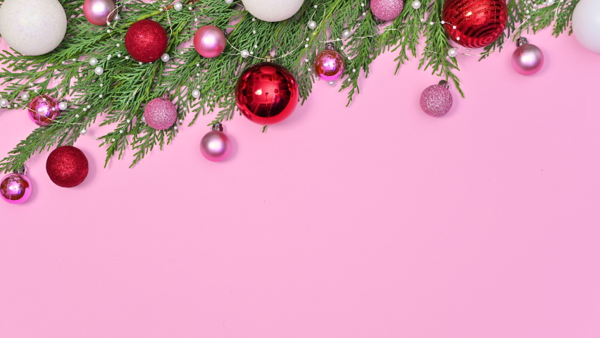 6k Red pink and white Christmas ornaments come on Christmas pine garland on top of pastel pink theme. Stop motion | Shutterstock HD Video #1081241939