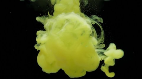 Slow motion yellow ink acrylic paint mixing in water, swirling softly underwater. Colored acrylic cloud of paint isolated. Abstract smoke explosion animation. Beautiful art background