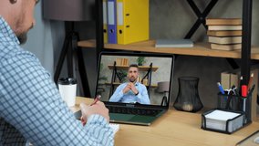 Online business meeting. Man employee at home office listen CEO director remote video call webcam chat computer, writes in notebook. Businessman in laptop screen tells says tasks top manager company