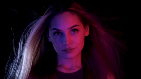 Blowing hair Portrait woman move colorful neon led light. Glamour face fashion ultraviolet illuminance. Luxury motion hair wind air girl led lighting. Style blow colors neon illumination ultra violet.