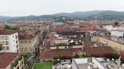 Narrow streets and colorful rooftops of Turin downtown, low altitude drone flying