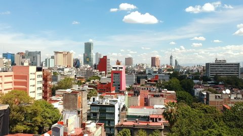 Aerial panoramic view of downtown Mexico City skyline towards the historic center (Centro Histórico) from Colonia Juarez. Drone slowly moving up.