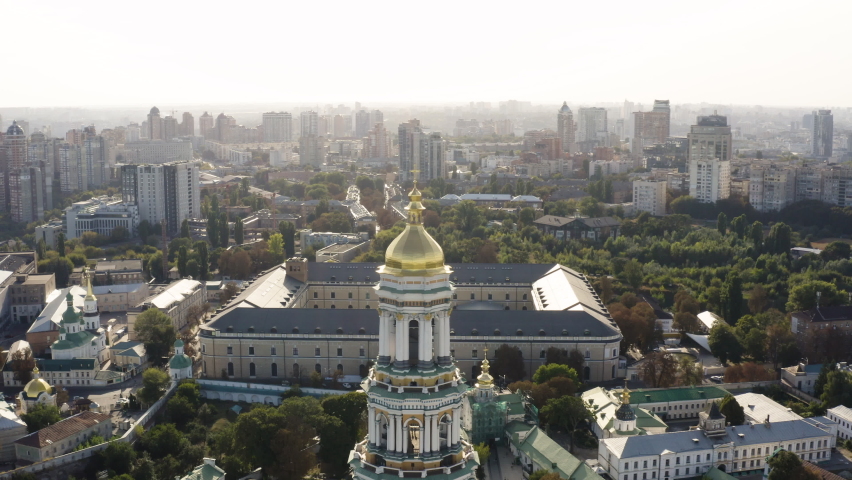Great Lavra Bell Tower of the ancient cave monastery of Kiev Pechersk Lavra with cityscape background, Kyiv(Kiev), Ukraine - aerial shot