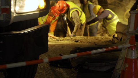 New York , United States - 10 22 2021: Parallax over Public workers digging a hole on the street of Manhattan to perform repair