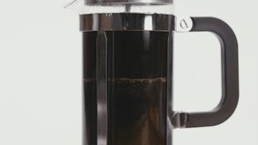 Close up on Pushing Down Slowly the Lid of French Press, Preparing Freshly Brewed Coffee - Powered by Shutterstock - Get 15% off with code: PIKWIZARD15
