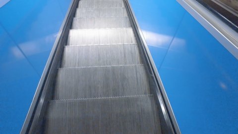 empty escalator in underground moving down
