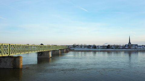 The Loire in flood under the Sully sur Loire bridge in Europe, in France, in the Center region, in the Loiret, towards Orléans, in Winter, during a sunny day.